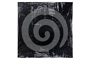 Black vinyl record cover wrapped in plastic