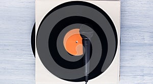 On a black vinyl record, there is a microphone for vocals of retro songs, top view