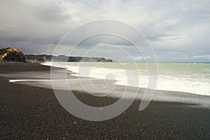 Black volcanic Beach Whirinaki Beach, Hawke`s Bay Napier, North Island of New Zealand