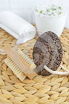 Black volcanic pumice stone and massage foot brush with natural bristles. Homemade spa and diy pedicure concept