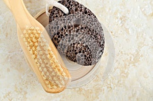 Black volcanic pumice stone and massage foot brush. Natural spa, pedicure and foot calluses removal. Top view, copy space