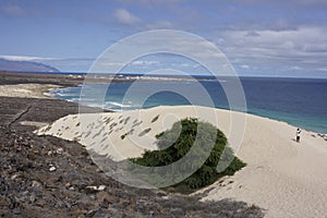 Black volcanic rocks and white sand in Cape Verde Islands photo