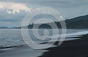 Black volcanic sand beach in Tangkoko National Park, Sulawesi, Indonesia