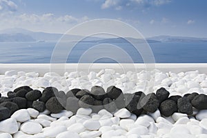 Black volcanic stones over white. Decoration detail at Santorini island