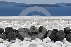 Black volcanic stones over white. Decoration detail at Santorini island