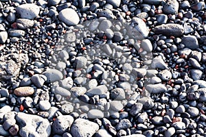 Black vulcanic stones on a black sand beach as a background, El Golfo, Lanzarote, Canary Islands, Spain