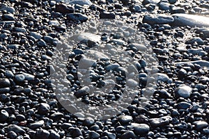 Black vulcanic stones on a black sand beach as a background, El Golfo, Lanzarote, Canary Islands, Spain