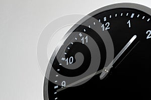 Quarter to two setting on the black wall clock