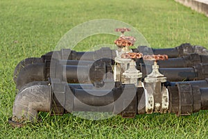 Black water pipes joined with rusty red valves for safety and clean watering system in modern building construction and industrial