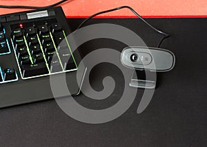 A black webcam on a computer desk.