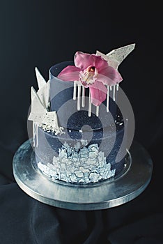 Black Wedding cake decorated with white chocolate and Orchid flower