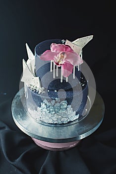 Black Wedding cake decorated with white chocolate and Orchid flower