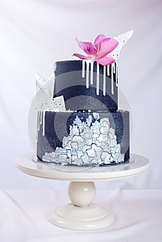 Black Wedding cake decorated with white chocolate and Orchid flower