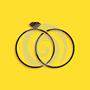 Black Wedding rings icon isolated on yellow background. Bride and groom jewelery sign. Marriage icon. Diamond ring. Long