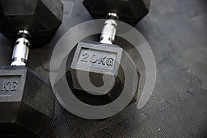 Black weights on black rubber flooring bodybuilding equipment 20 kg