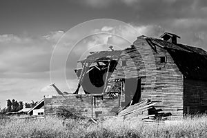Black and white abandoned barn, aftermath of storm