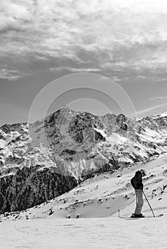 Black-and-white Alpine landscape and the skier in the foreground