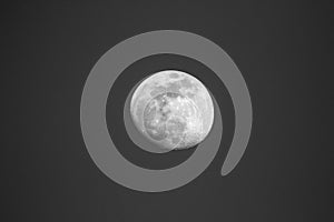 A black and white art portrait of the moon surrounded by the darkness and emptyness of space. All craters and other details of the photo