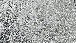Black and white background of aluminum swarf tangled on a heap