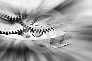 Black and white background. Metal Cogwheels in clock mechanism. Macro