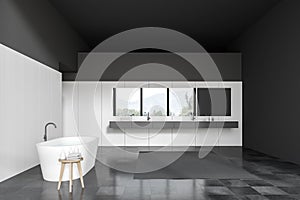 Black and white bathroom with tub and sink