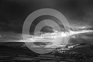 Black and white beautiful sunbeams over Big Moor in the Peak Dis