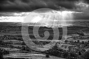 Black and white beautiful sunbeams over Big Moor in the Peak Dis