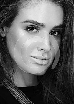 Black and white beauty closeup portrait of beautiful young woman with wet hair and professional makeup