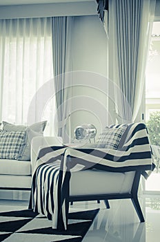 Black and white blanket on modern chair - vintage picture style