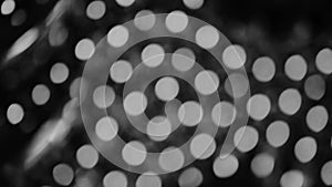 Black and white blurred abstract bokeh black background for backdrop, twinkled bright bokeh defocused and sparkles background.