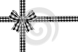 Black and white buffalo plaid Christmas gift bow and ribbon arranged as wrapped gift box isolated on white