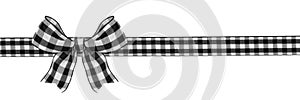 Black and white buffalo plaid Christmas gift bow and ribbon long border isolated on white