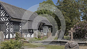 Black and white building in a church yard