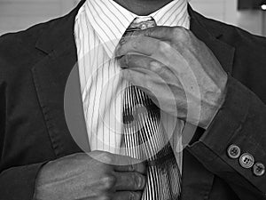 Black and white Business Man fixing his suit