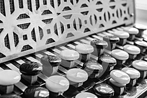 Black and white buttons on button accordion close-up