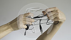 Black and white cables in a woman`s hand on  background