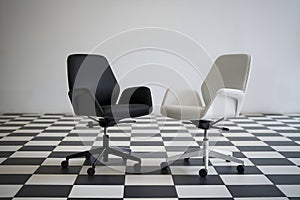 Black and white chairs on checkered floor, emphasizing modern office style