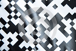 Black and white checkered glossy paper background as background close-up