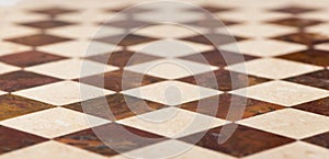 Black and white checkered marble floor with sunlight