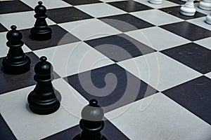 Black and white chess board with black pawns