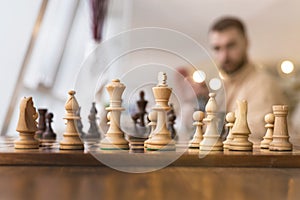 Black and white chess figures on a chessboard, closeup. Set of chess figures on the playing board