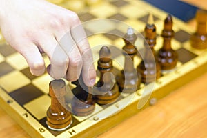 Black and white chess pieces on a chessboard, closeup. Set of chess figures on the playing board