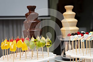 black and white chocolate waterfall with fruits and marshmallow photo