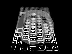 Black and white close-up on illuminated keys of computer keyboard