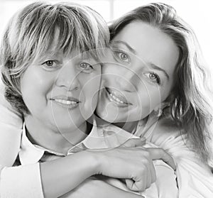 Black and white close up portrait of a mature mother and adult d