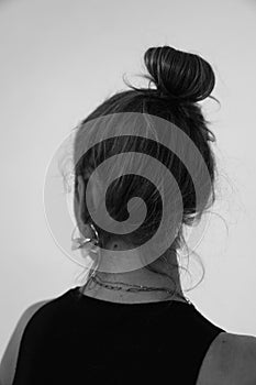 Black and white close-up of young woman with hair bum, rear view. Mock-up.