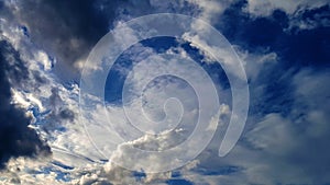 Black and white clouds on blue sky