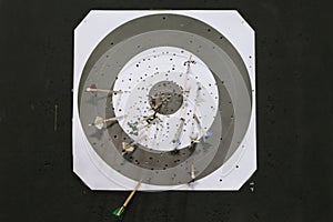 Black and white colored archery target with arrows