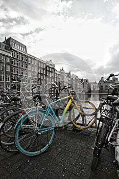 Black and white colorsplash Close up of a typical dutch Amsterdam colorful bike and houses in Holland