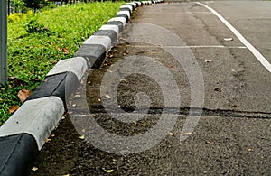 Black and white concrete road curb